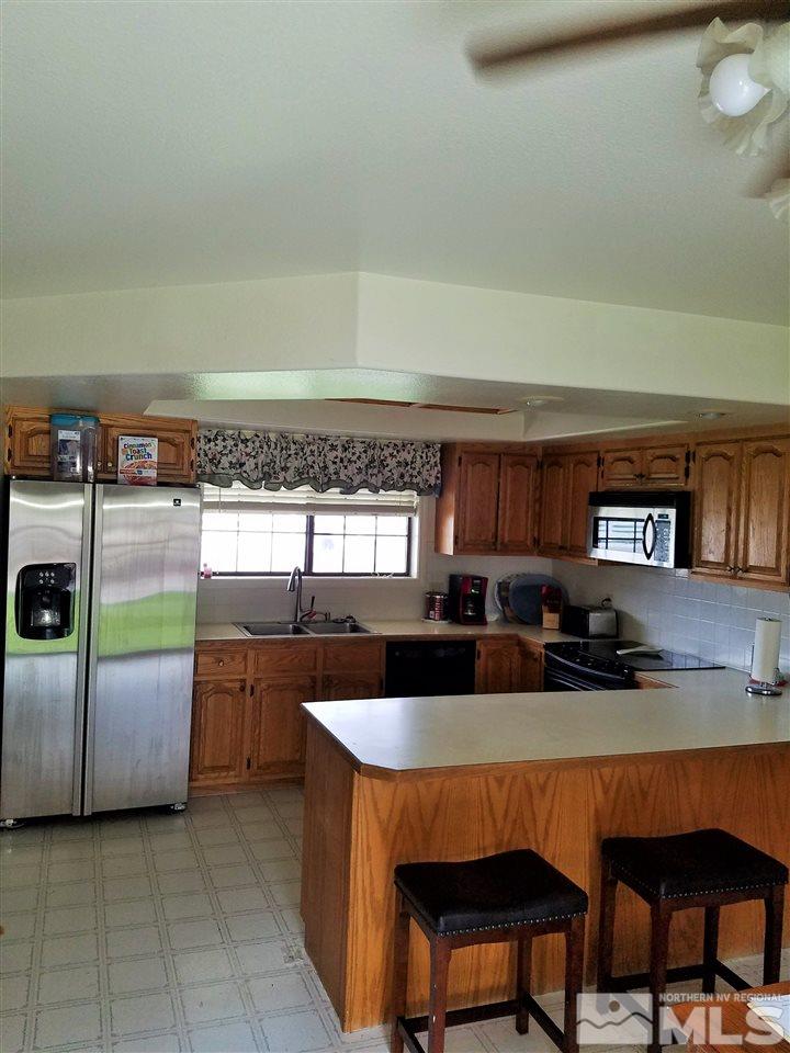 2580 Rice Road Fallon, NV 89406 - Photo 9 of 25 a kitchen with a sink a counter space and dining table