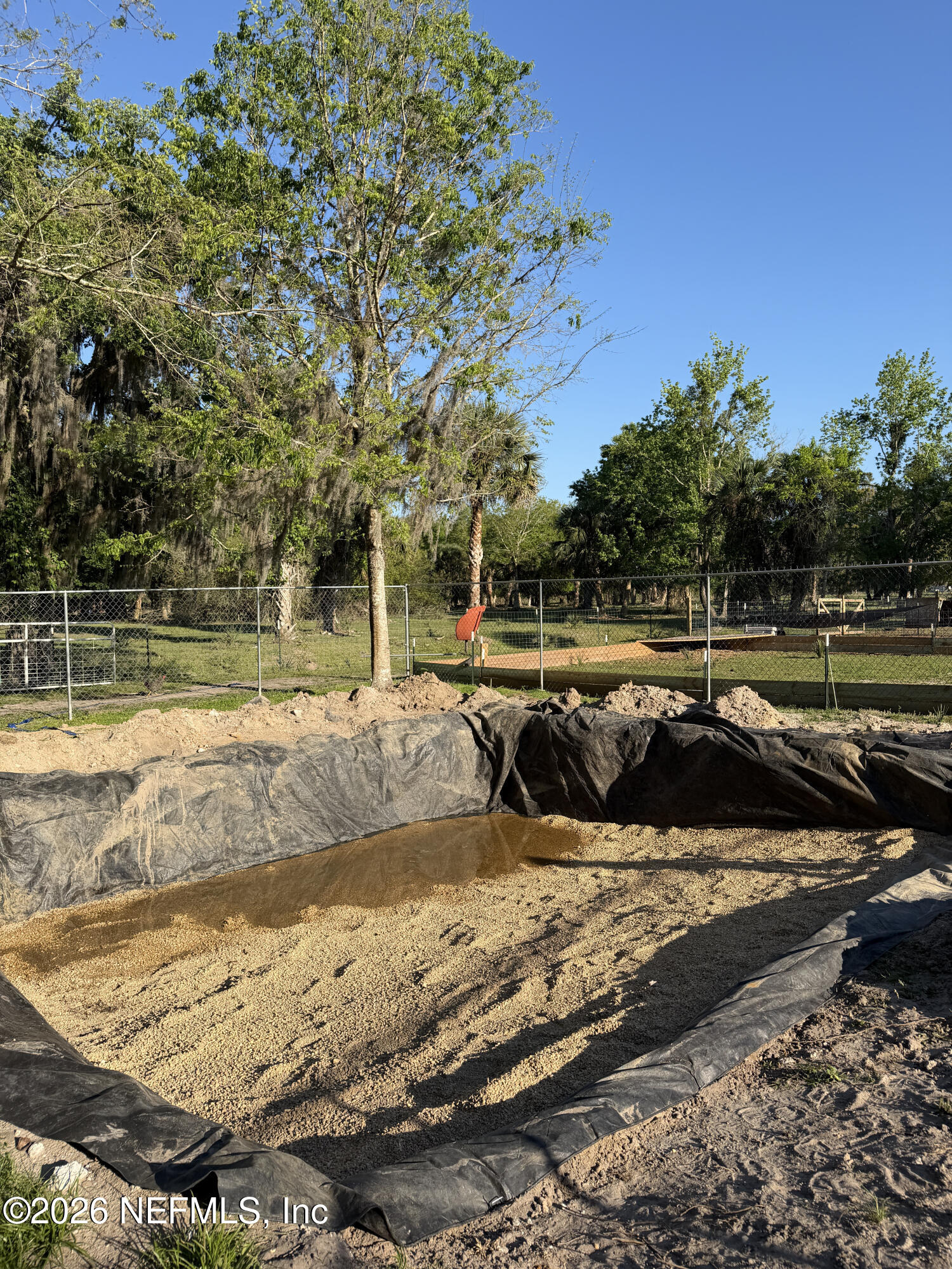 1133 Turnbull Grove Road Oak Hill, FL 32759 - Photo 6 of 14 a view of swimming pool with a yard and sitting area