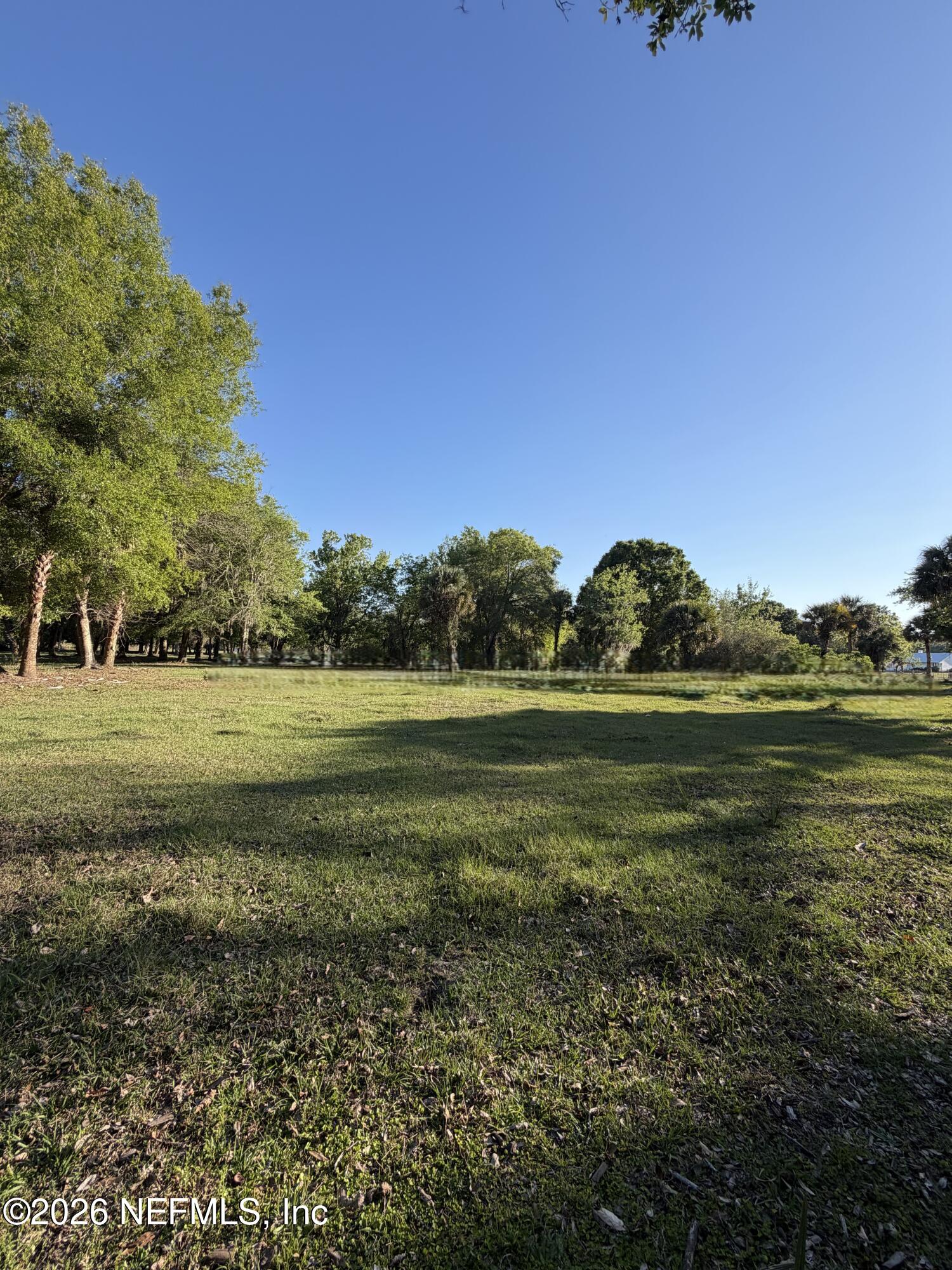 1133 Turnbull Grove Road Oak Hill, FL 32759 - Photo 7 of 14 a view of a golf course with a lake
