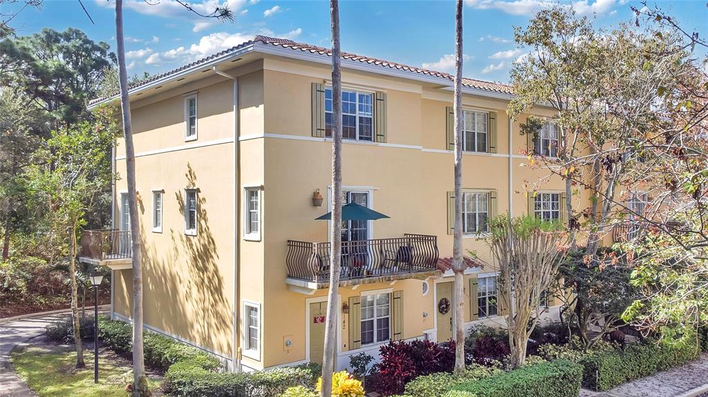 a front view of a building with a garden