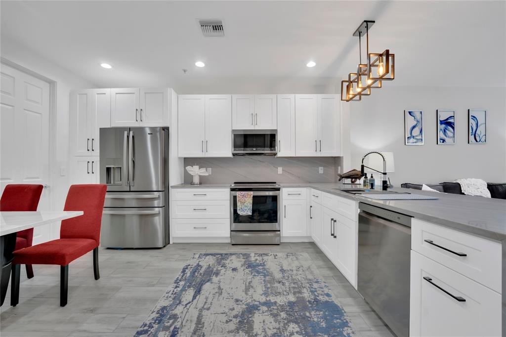 142 Morning Dew Circle, Unit 142 Jupiter, FL 33458 - Photo 12 of 34 a kitchen with a refrigerator stove and sink