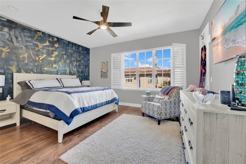 142 Morning Dew Circle, Unit 142 Jupiter, FL 33458 - Photo 15 of 34 a bedroom with a bed couch and window