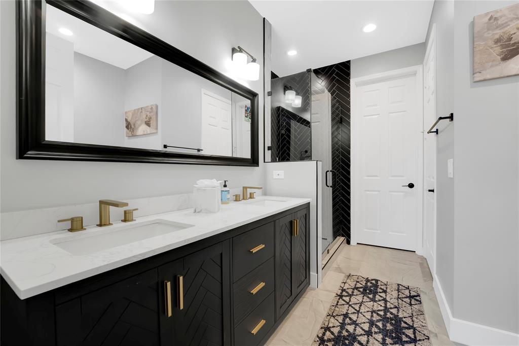 142 Morning Dew Circle, Unit 142 Jupiter, FL 33458 - Photo 16 of 34 a bathroom with a sink a mirror a vanity and a shower