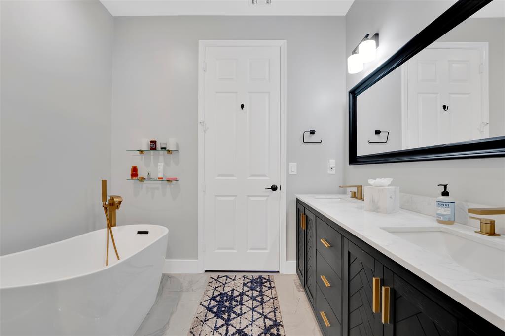 142 Morning Dew Circle, Unit 142 Jupiter, FL 33458 - Photo 17 of 34 a bathroom with a tub sink and mirror