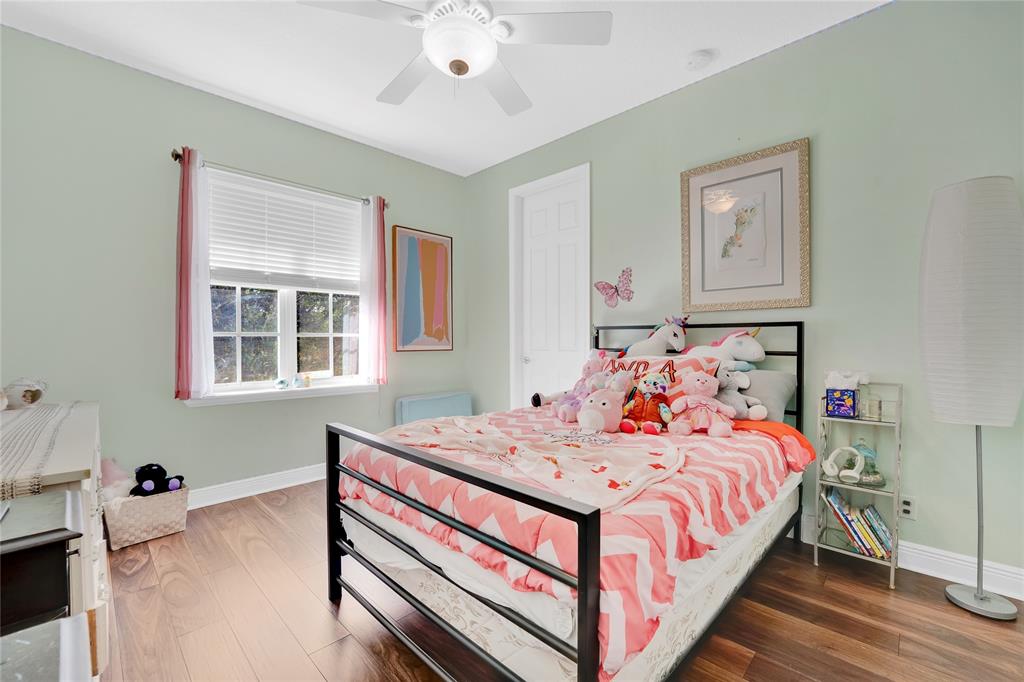 142 Morning Dew Circle, Unit 142 Jupiter, FL 33458 - Photo 19 of 34 a bedroom with a bed and a window