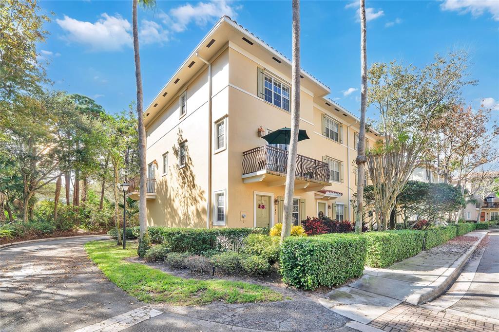 142 Morning Dew Circle, Unit 142 Jupiter, FL 33458 - Photo 2 of 34 a view of a large white building with a yard