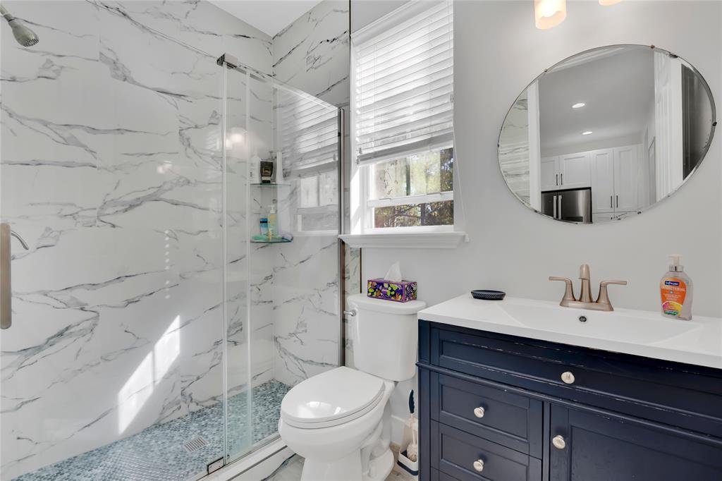 142 Morning Dew Circle, Unit 142 Jupiter, FL 33458 - Photo 21 of 34 a bathroom with a sink toilet vanity and shower