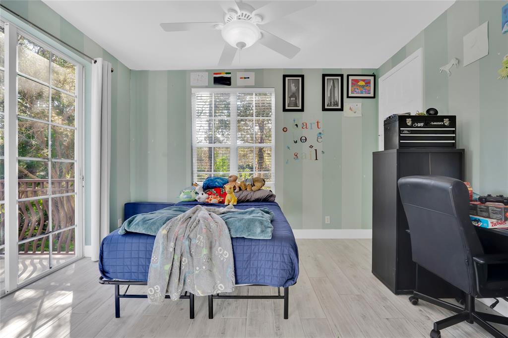 142 Morning Dew Circle, Unit 142 Jupiter, FL 33458 - Photo 22 of 34 a bed room with furniture and a window