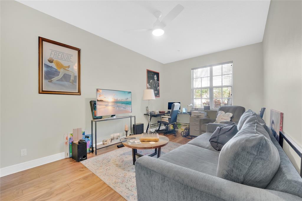 142 Morning Dew Circle, Unit 142 Jupiter, FL 33458 - Photo 23 of 34 a living room with furniture and a window