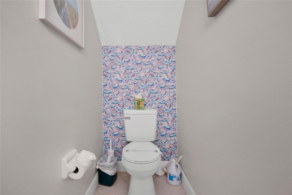 142 Morning Dew Circle, Unit 142 Jupiter, FL 33458 - Photo 24 of 34 a white toilet sitting next to a shower curtain