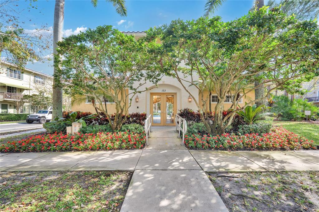 142 Morning Dew Circle, Unit 142 Jupiter, FL 33458 - Photo 27 of 34 a front view of a house with a yard and potted plants