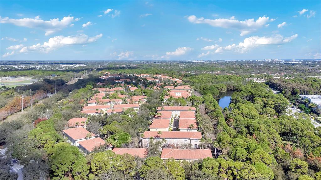 142 Morning Dew Circle, Unit 142 Jupiter, FL 33458 - Photo 32 of 34 an aerial view of residential houses with outdoor space and trees