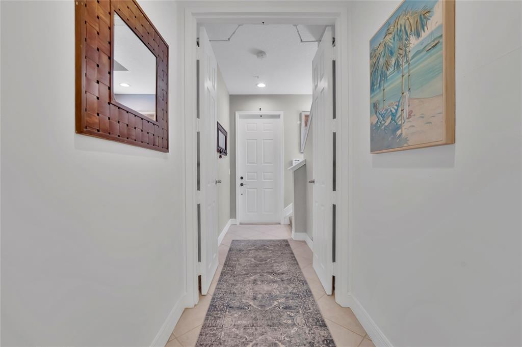 142 Morning Dew Circle, Unit 142 Jupiter, FL 33458 - Photo 6 of 34 a view of a hallway with wooden floor and entryway