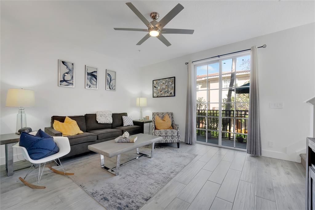 142 Morning Dew Circle, Unit 142 Jupiter, FL 33458 - Photo 7 of 34 a living room with furniture and a floor to ceiling window