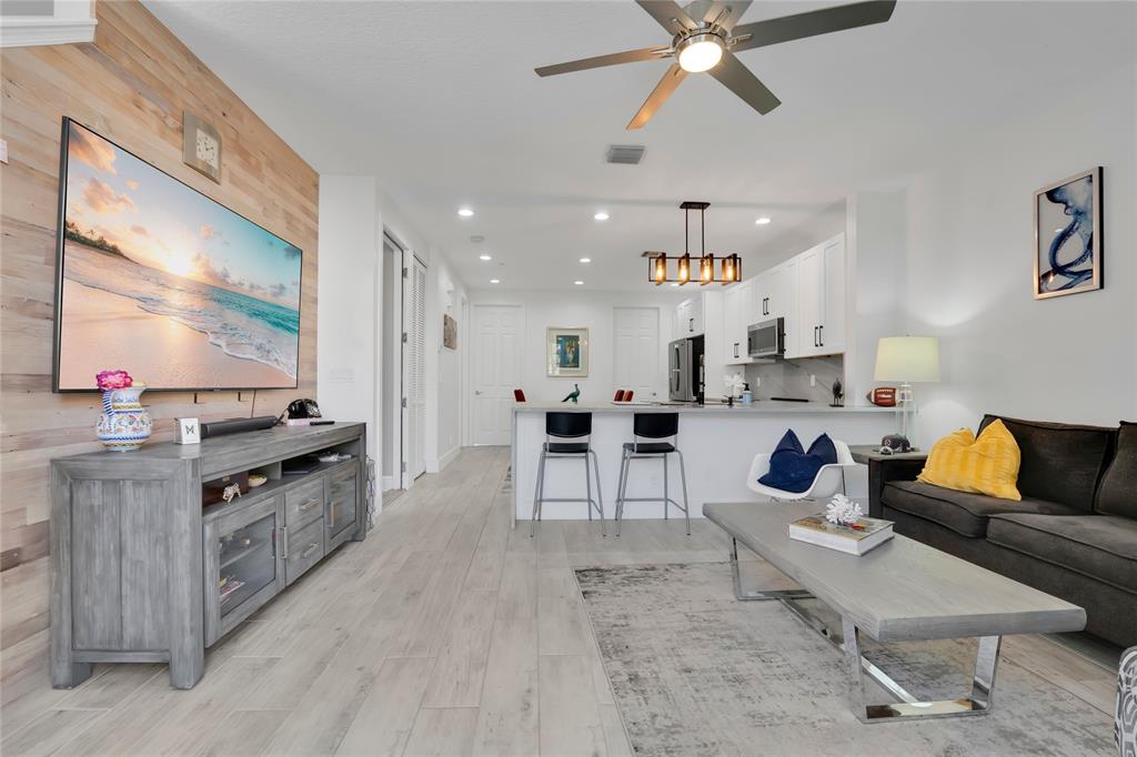 142 Morning Dew Circle, Unit 142 Jupiter, FL 33458 - Photo 9 of 34 a living room with furniture and a flat screen tv