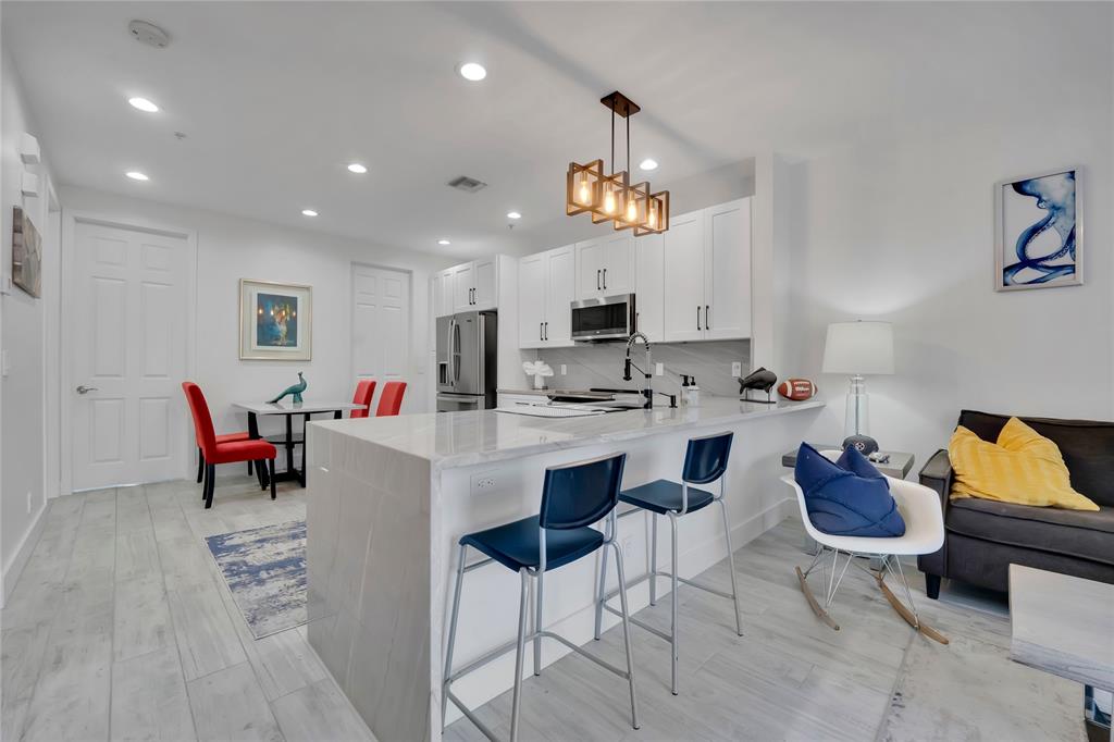 142 Morning Dew Circle, Unit 142 Jupiter, FL 33458 - Photo 10 of 34 a living room with furniture and kitchen view