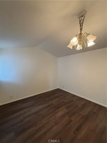 a view of a room with wooden floor and a window