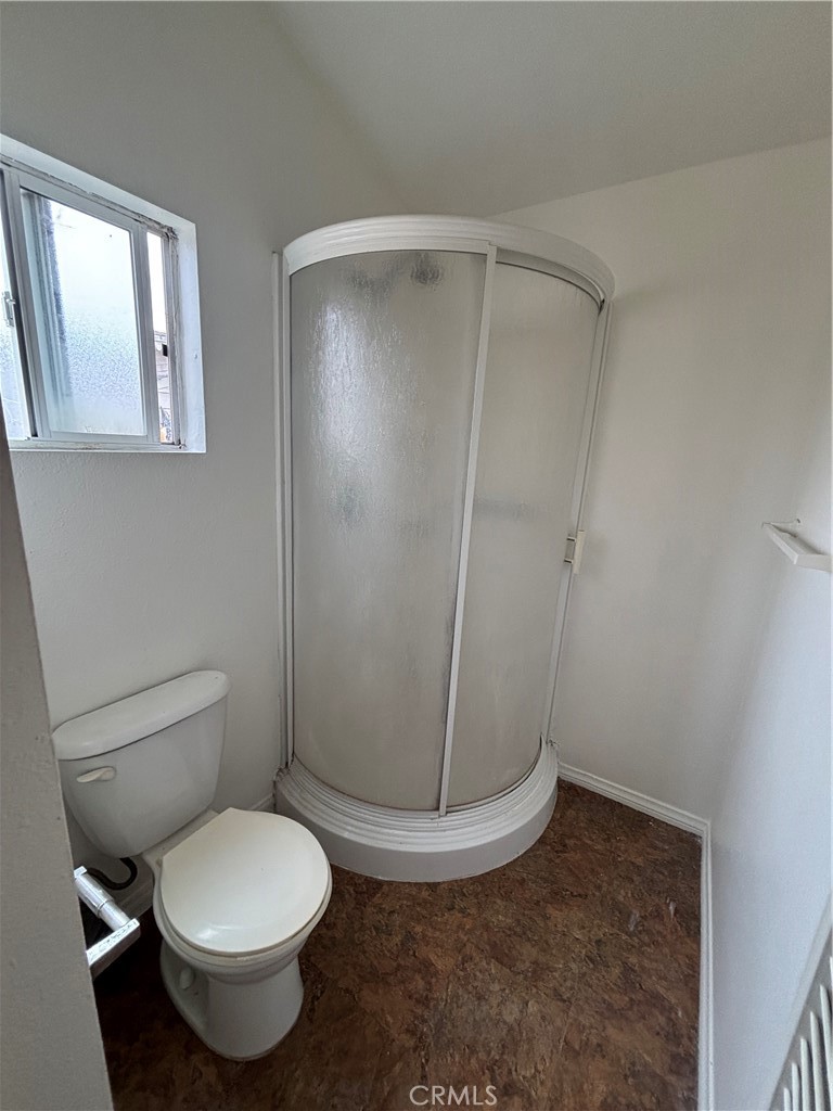 24627 B Moon Avenue Lomita, CA 90717 - Photo 7 of 7 a white toilet sitting next to a shower