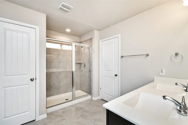a bathroom with a shower and sink