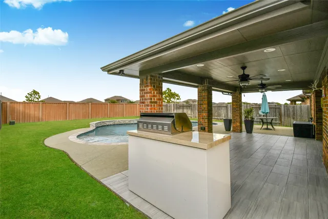 a view of a backyard with table and chairs