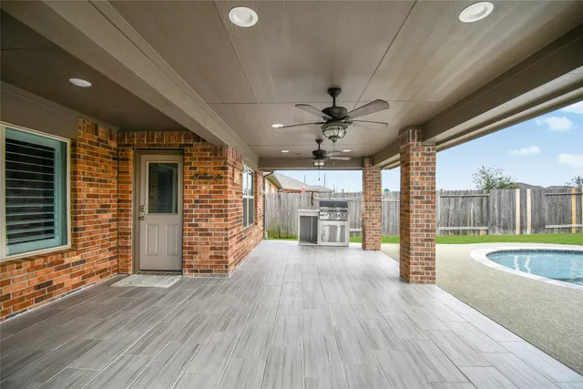 a view of a livingroom with wooden floor and a ceiling fan