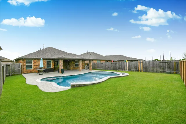 a front view of a house with yard and green space