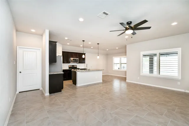 a view of kitchen with refrigerator and window