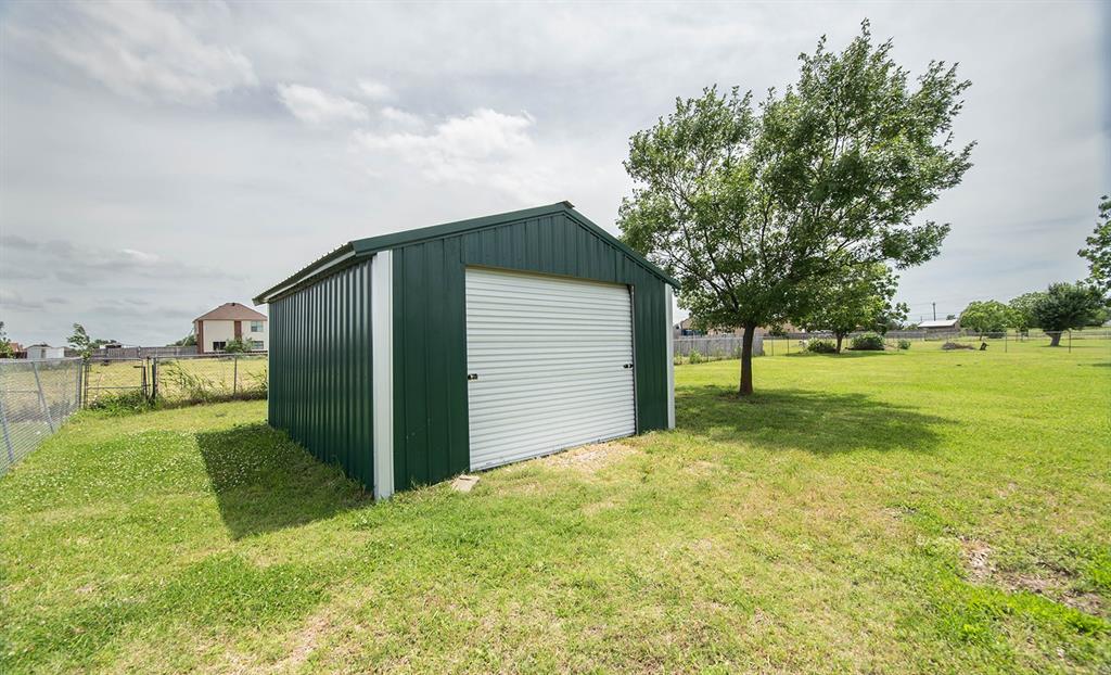 10336 Jennifer Circle Forney, TX 75126 - Photo 33 of 37 This is the workshop/ storage/ shed. No electricity but perfect for riding mower, lawn equipment, storage, or any special needs you may have. The roll up door offers easy access for mower.
