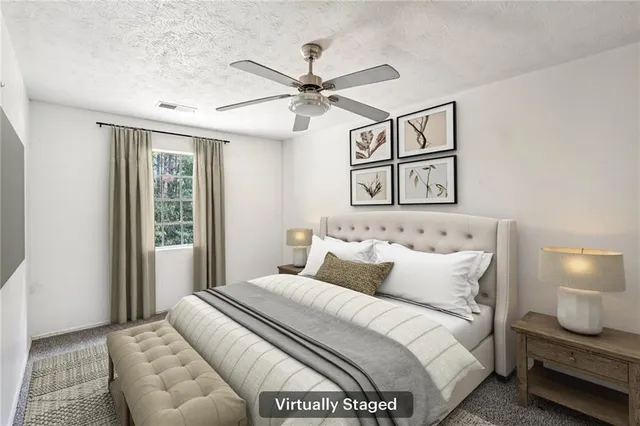 a bedroom with a large bed and a chandelier