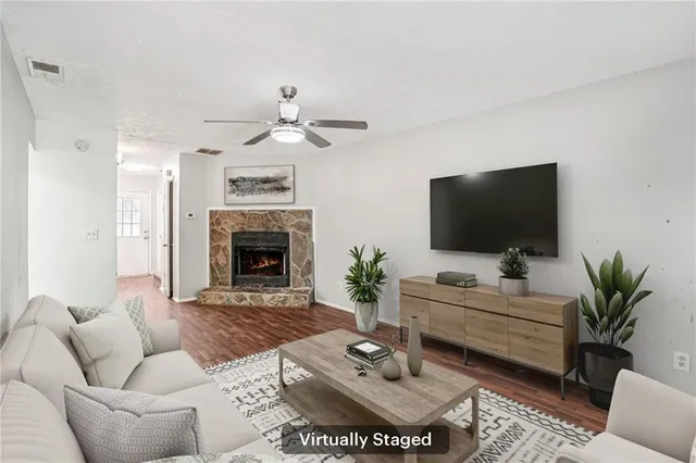 a living room with furniture a fireplace and a flat screen tv
