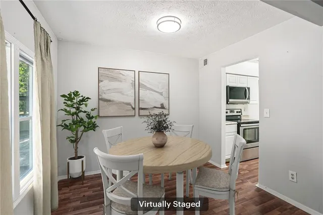 a view of a dining room with furniture and wooden floor