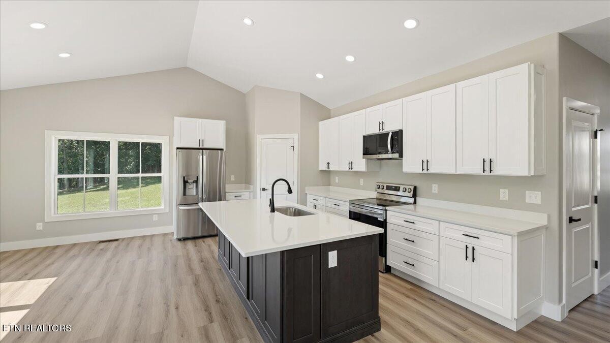 5817 Caldwell Road Loudon, TN 37774 - Photo 11 of 43 a kitchen with a sink a stove a microwave and cabinets
