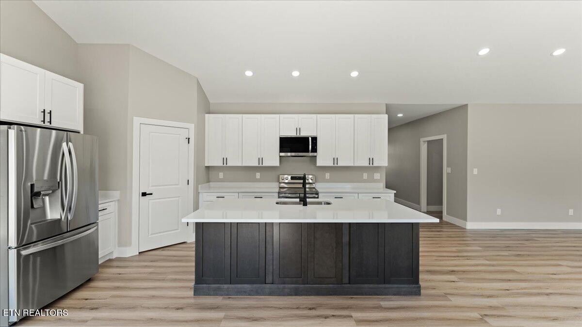 5817 Caldwell Road Loudon, TN 37774 - Photo 13 of 43 a kitchen with stainless steel appliances granite countertop a sink stove and refrigerator