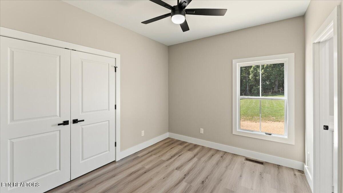 5817 Caldwell Road Loudon, TN 37774 - Photo 29 of 43 a view of an empty room with wooden floor and a window