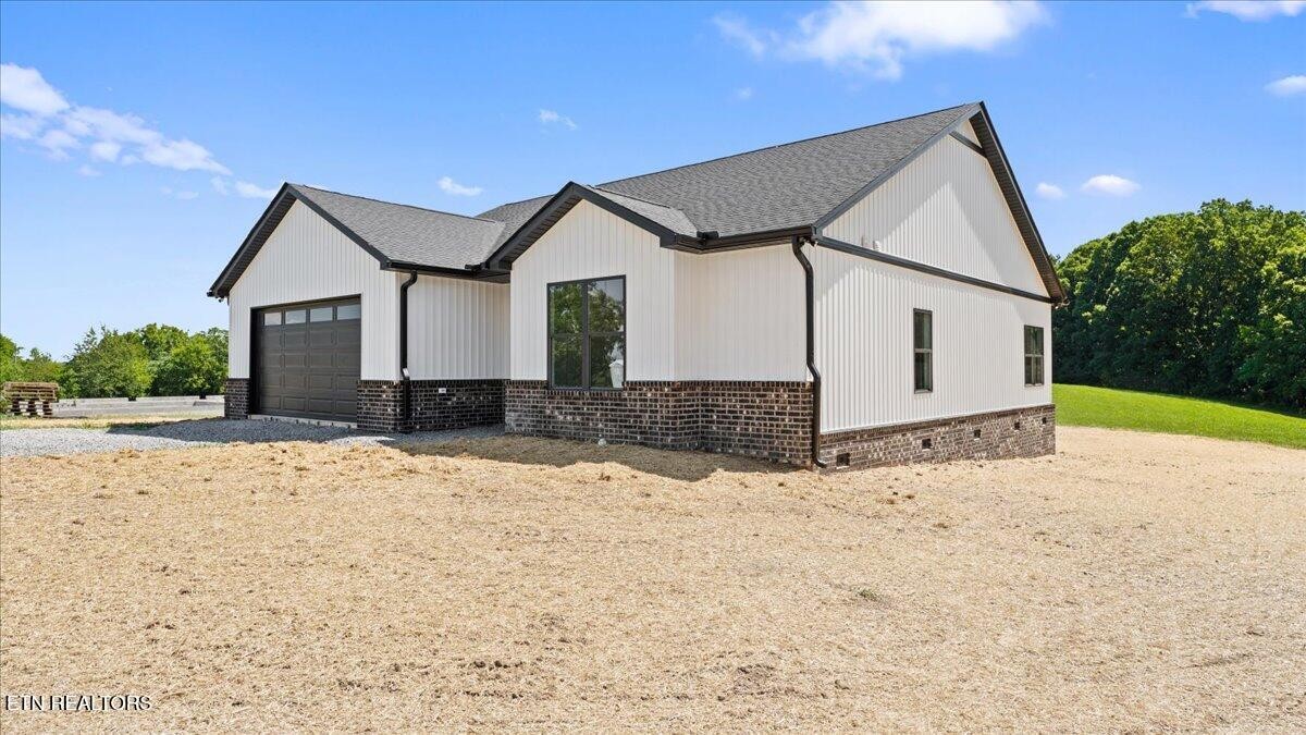 5817 Caldwell Road Loudon, TN 37774 - Photo 3 of 43 a front view of a house with a yard and garage