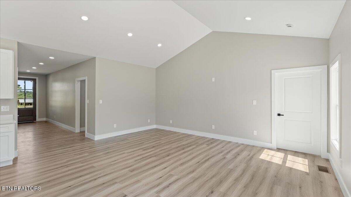 5817 Caldwell Road Loudon, TN 37774 - Photo 6 of 43 an empty room with wooden floor and windows