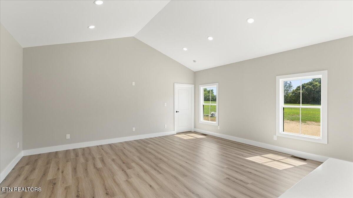 5817 Caldwell Road Loudon, TN 37774 - Photo 8 of 43 an empty room with wooden floor and windows