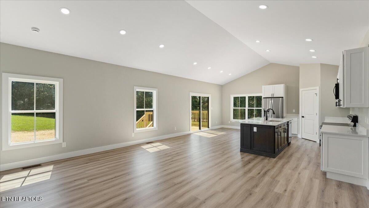 5817 Caldwell Road Loudon, TN 37774 - Photo 9 of 43 a view of an empty room with wooden floor and a window