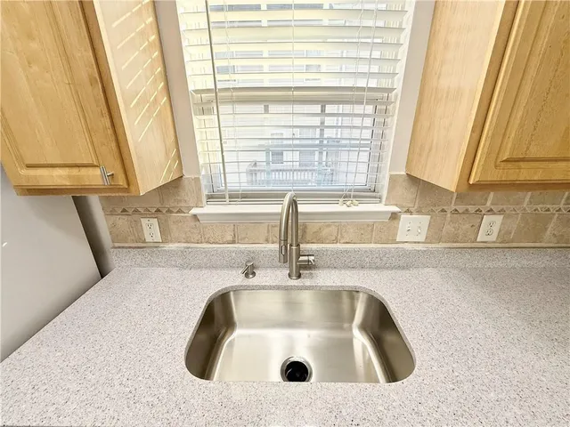a bathroom with a sink and a window