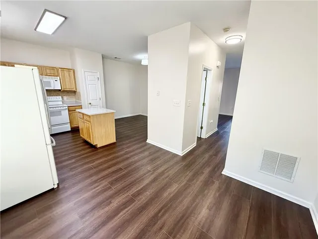 a view of a room with wooden floor and a window