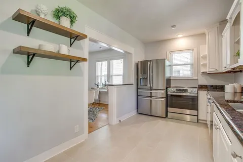 a kitchen with stainless steel appliances a refrigerator and a stove top oven