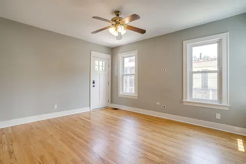 wooden floor in an empty room with a window