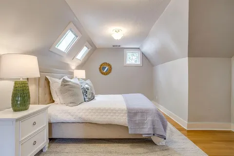 a bedroom with a bed and a lamp