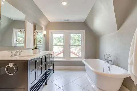 a white bath tub sitting next to a window