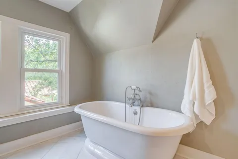 a bathroom with a granite countertop shower a toilet and a shower