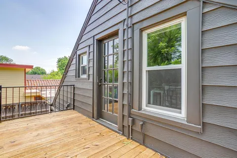 a view of a balcony and yard