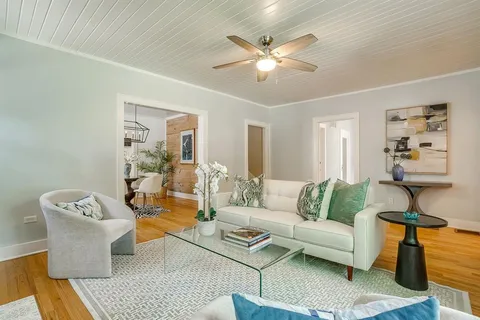 a living room with furniture and a chandelier