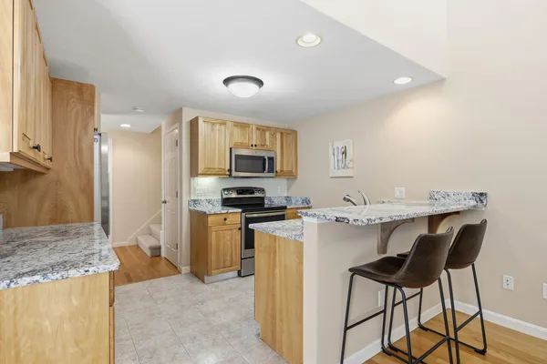 a kitchen with kitchen island a sink stove and refrigerator