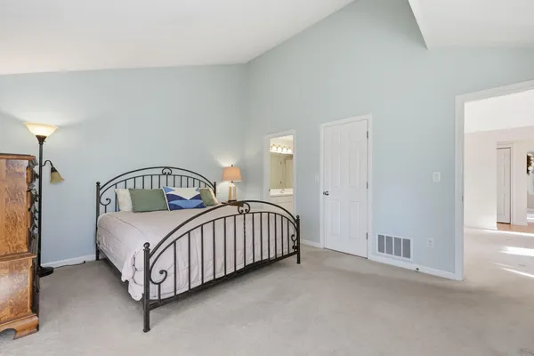 a bedroom with a bed window and a baby crib