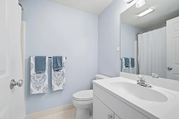 a bathroom with a sink toilet and mirror